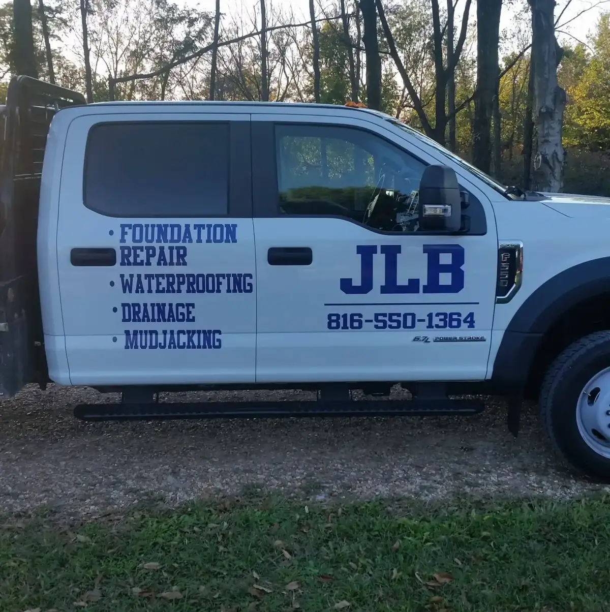 Angled front view of JLB company truck — professional foundation service in Shawnee