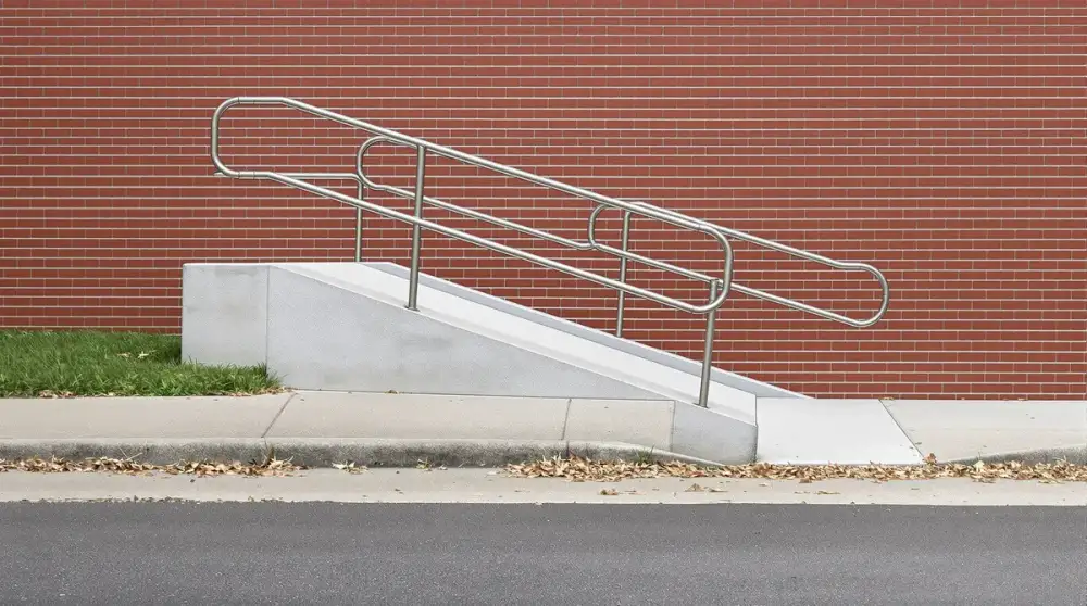 Concrete ADA ramp with handrail in Ames, Iowa
