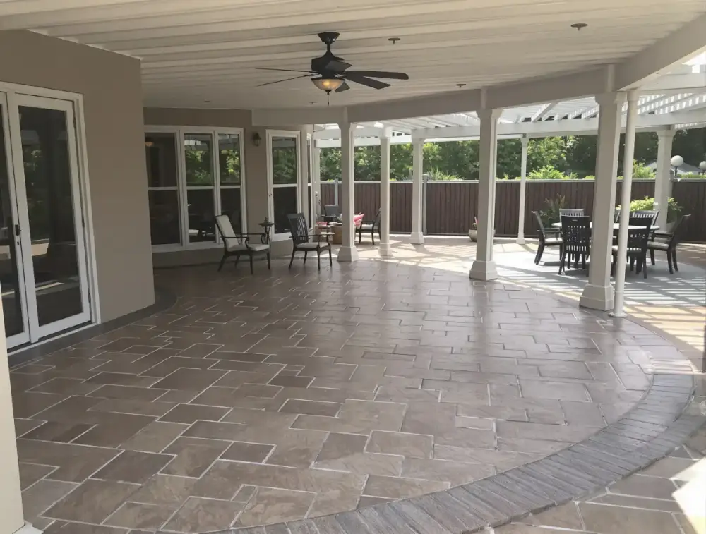 Two-tone concrete patio under a pergola — patios by JLB in Ames, Iowa