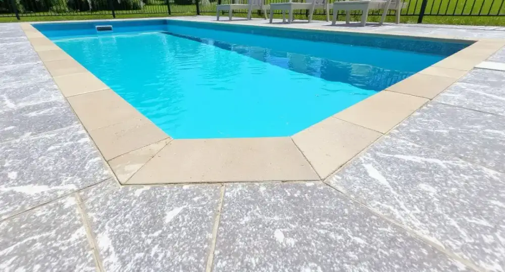 Slip-textured concrete pool deck at the coping — pool decks by JLB in Clive, Iowa