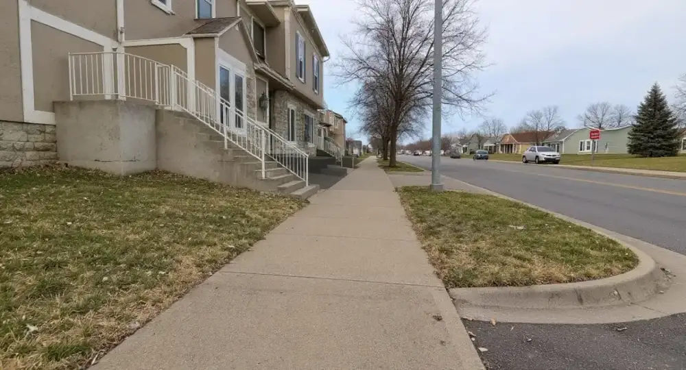 Public concrete sidewalk with an ADA curb ramp — sidewalks by JLB in Grimes, Iowa