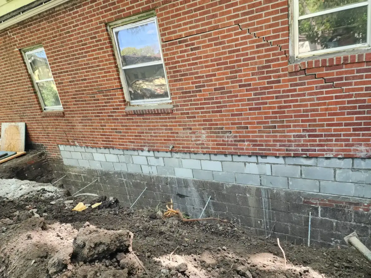 Carbon fiber wall bracing strips installed on bowing basement wall