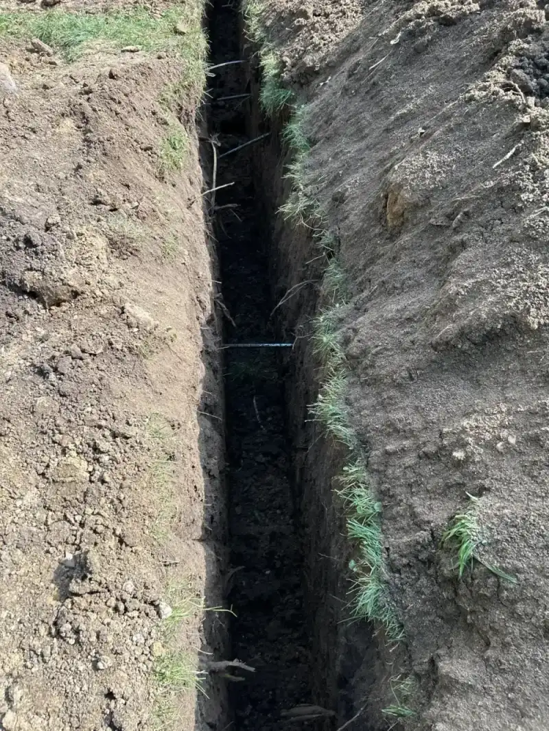 1950s Poured concrete basement wall in Gladstone receiving wall anchors — JLB trench fully open
