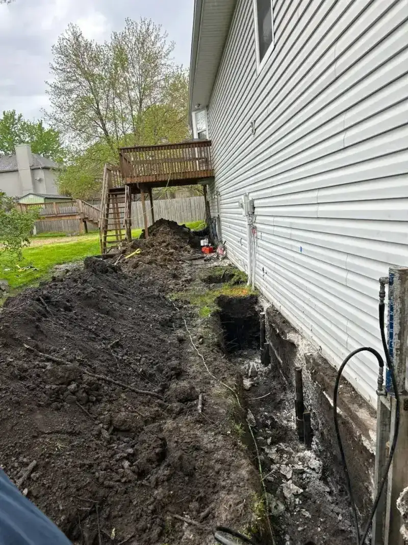 Steel push pier driven to bedrock for foundation stabilization