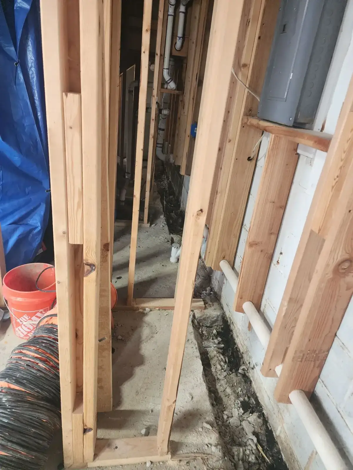 Interior basement waterproofing system with drainage channels and sump pump